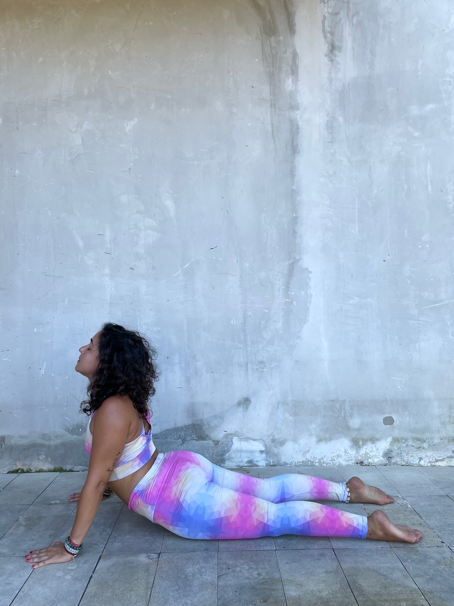 Inês Varela, an Om Reset Yoga Instructor, is in cobra pose.
